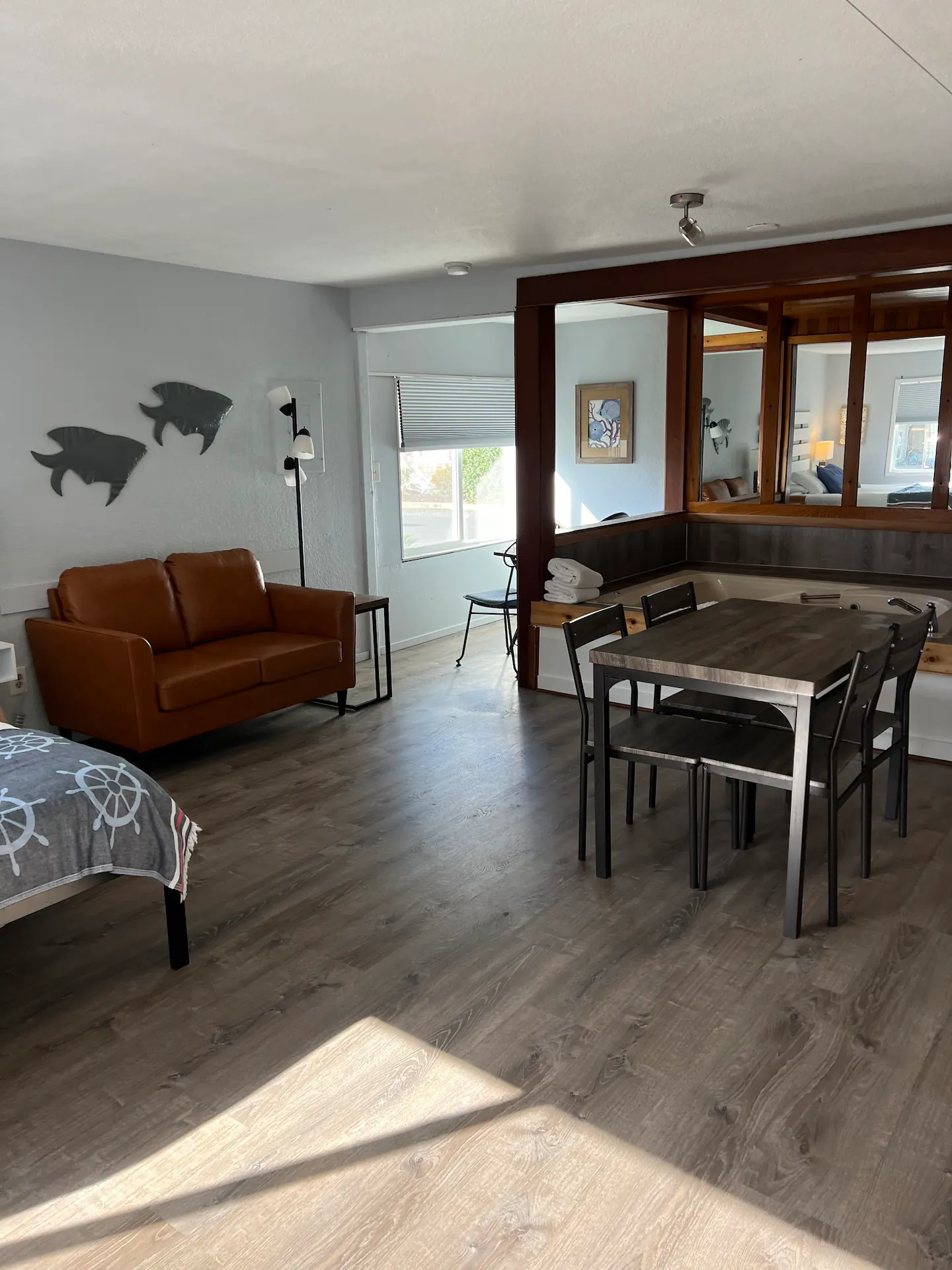 Common area with couch, small dining table and window seating